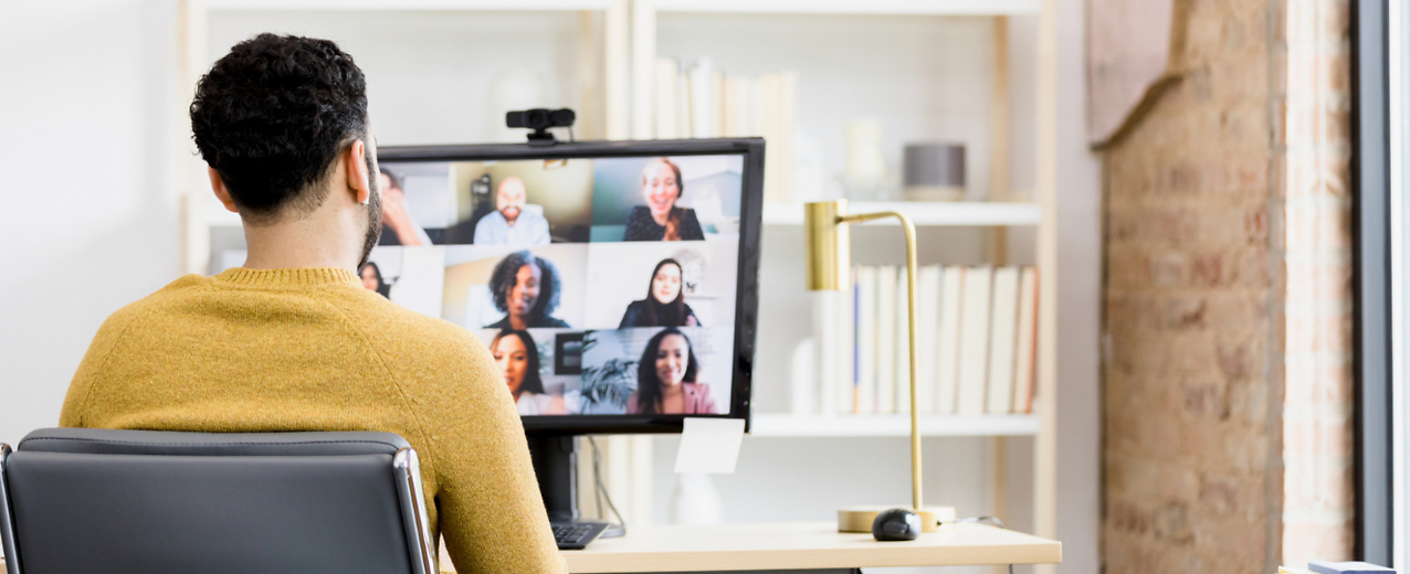 Person sitting in front of computer meeting with a group virtually