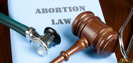 abortion law book with gavel and stethoscope