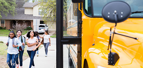 kids walking by a school bus
