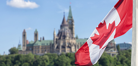 canadian flag in front of parliament building