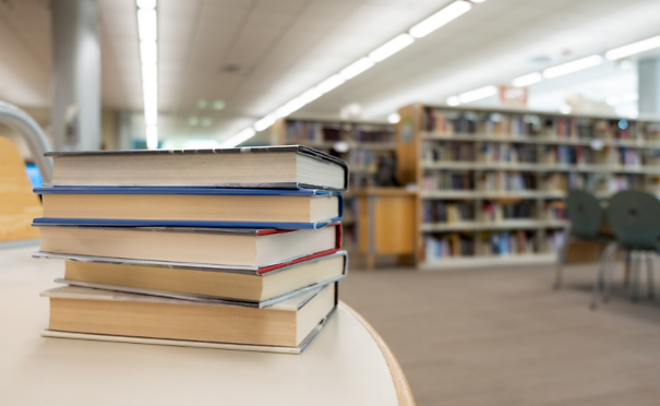 Stack of books on table at library