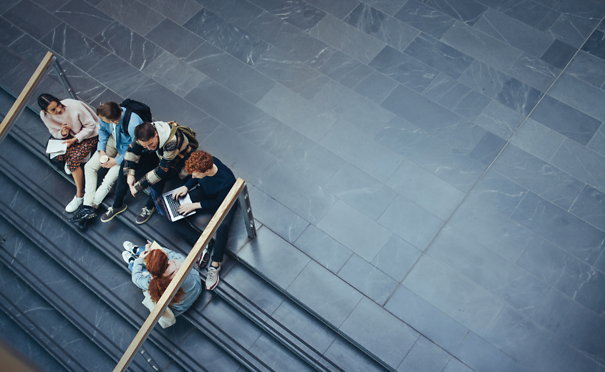 Students sitting and talking on stairs