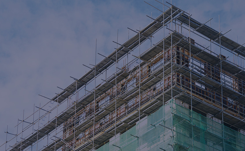 Scaffolding that is on a building that is under construction