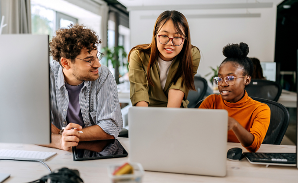 Three young colleagues discussing work at modern office