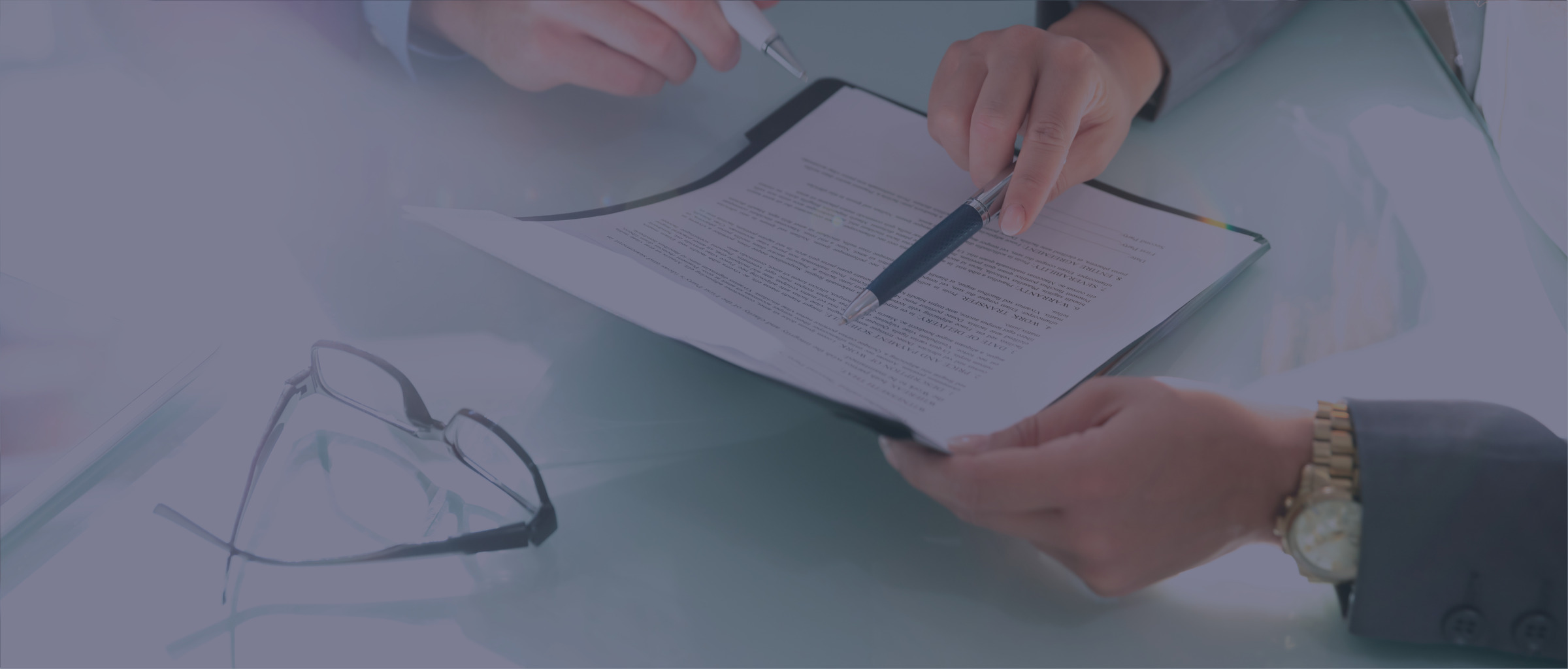 Two people sitting at a desk reviewing documents