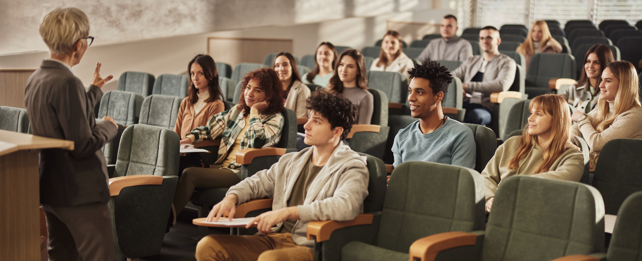 Students being lectured by a professor in an auditorium