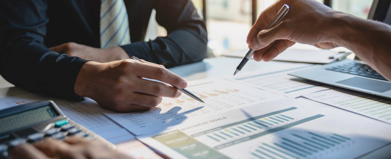 business people analysis cost graph on the desk in the meeting room