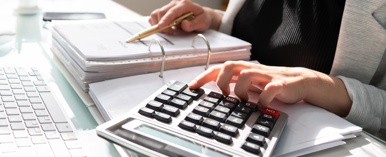 Person typing numbers into a calculator