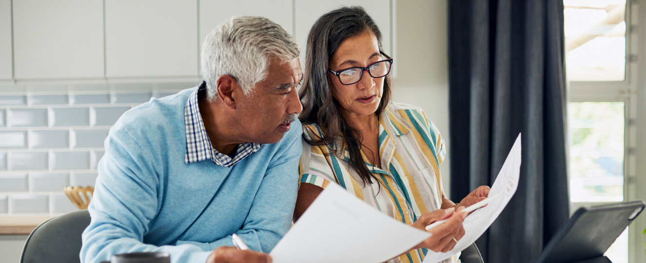 Two people reviewing financial documents