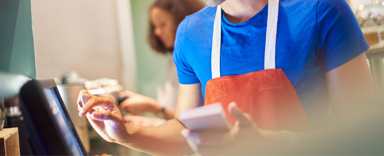 Coffee shop worker with digital order screen